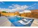 Sun-soaked pool featuring built in tanning ledge and umbrella, perfect for cooling off on a hot day at 7829 W Warner St, Phoenix, AZ 85043