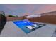 Inviting pool featuring lounge chairs with sun umbrella, plus a water feature for relaxed outdoor living at 7829 W Warner St, Phoenix, AZ 85043