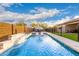 A backyard pool with a waterfall feature and lounge chairs offers a relaxing outdoor space at 7829 W Warner St, Phoenix, AZ 85043