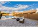 Backyard features a sparkling pool, a fire pit and lounge chairs at 7829 W Warner St, Phoenix, AZ 85043
