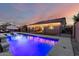 This stunning pool features a waterfall, sleek lounge chairs, and beautiful lighting for relaxation at 7829 W Warner St, Phoenix, AZ 85043