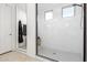 Modern bathroom showcases a large glass walk-in shower with white marble tile at 7829 W Warner St, Phoenix, AZ 85043