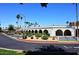 Community clubhouse with lush landscaping and mature palm trees, offering a welcoming atmosphere at 7920 E Camelback Rd # 612, Scottsdale, AZ 85251