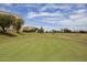 Golf course view featuring a lush green putting green, flag and picturesque surroundings at 7920 E Camelback Rd # 612, Scottsdale, AZ 85251