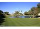 Beautiful golf course view featuring a lush green putting green, pond, and picturesque surroundings at 7920 E Camelback Rd # 612, Scottsdale, AZ 85251