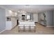 Spacious eat-in kitchen featuring white cabinets, stainless steel appliances, and an island with seating at 7920 E Camelback Rd # 612, Scottsdale, AZ 85251