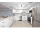 Renovated kitchen with white cabinetry, stainless steel appliances, and marble countertops at 7920 E Camelback Rd # 612, Scottsdale, AZ 85251