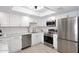 Bright kitchen features white cabinets, stainless steel appliances, and updated hardware at 7920 E Camelback Rd # 612, Scottsdale, AZ 85251