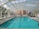 Indoor pool area featuring lounge chairs and a unique vaulted ceiling for year-round enjoyment at 7920 E Camelback Rd # 612, Scottsdale, AZ 85251