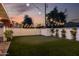Backyard putting green surrounded by lush artificial turf and decorative string lights, perfect for recreation at 8021 N 16Th Dr, Phoenix, AZ 85021