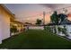 Expansive backyard with manicured artificial turf, covered patio and decorative string lights for outdoor entertaining at 8021 N 16Th Dr, Phoenix, AZ 85021