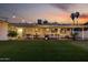 Inviting backyard featuring an outdoor living area, string lights, and well-maintained artificial turf at 8021 N 16Th Dr, Phoenix, AZ 85021