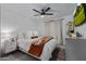 Comfortable bedroom featuring bright natural light, a ceiling fan, and stylish decor at 8021 N 16Th Dr, Phoenix, AZ 85021