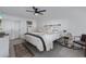 Well-lit bedroom showcasing neutral decor, gold accents, and a comfortable seating area at 8021 N 16Th Dr, Phoenix, AZ 85021