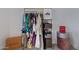 Bedroom wardrobe with a gold rack displaying clothing items and designer storage boxes at 8021 N 16Th Dr, Phoenix, AZ 85021