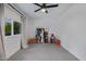Large bedroom with a window and ceiling fan with a rack to display clothing and bags at 8021 N 16Th Dr, Phoenix, AZ 85021