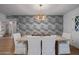 Dining room displaying a modern wood table, white chairs, stylish lighting, and cloud-patterned wallpaper at 8021 N 16Th Dr, Phoenix, AZ 85021