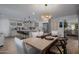 Open-concept dining area showcasing a wood table with seating adjacent to the modern kitchen at 8021 N 16Th Dr, Phoenix, AZ 85021