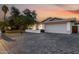 Spacious driveway leading to a home with a large garage, complemented by a well-maintained yard and desert landscaping at 8021 N 16Th Dr, Phoenix, AZ 85021