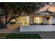 Charming home featuring a well-manicured lawn, a cozy front patio, and a welcoming front door with decorative wreath at 8021 N 16Th Dr, Phoenix, AZ 85021