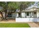 Charming home featuring a well-manicured lawn, a cozy front patio, and a welcoming front door with decorative wreath at 8021 N 16Th Dr, Phoenix, AZ 85021