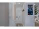 Hallway with a white door and neutral walls with decor at 8021 N 16Th Dr, Phoenix, AZ 85021