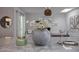 Close up of a kitchen island with marble countertop, decorative vase, and modern decor at 8021 N 16Th Dr, Phoenix, AZ 85021