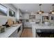 Spacious kitchen with marble countertops, white cabinets, and modern appliances at 8021 N 16Th Dr, Phoenix, AZ 85021