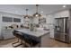 Bright kitchen featuring a spacious island, marble countertops, and stainless steel appliances at 8021 N 16Th Dr, Phoenix, AZ 85021