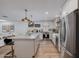 Well-lit kitchen boasts a central island, sleek appliances, and modern white cabinetry at 8021 N 16Th Dr, Phoenix, AZ 85021