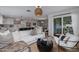 Open-concept living room and kitchen, showcasing comfortable seating and modern decor at 8021 N 16Th Dr, Phoenix, AZ 85021