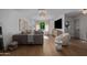 Cozy living room features modern décor, wood floors and a comfortable sofa bathed in sunlight at 8021 N 16Th Dr, Phoenix, AZ 85021