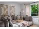 Close up of a sofa in a cozy living room with neutral tones, modern artwork, and bright natural lighting at 8021 N 16Th Dr, Phoenix, AZ 85021