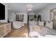 Spacious living area with hardwood floors, plush seating, modern decor, and ample natural light creates an inviting atmosphere at 8021 N 16Th Dr, Phoenix, AZ 85021