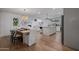 Open-concept living space with a dining area and kitchen featuring hardwood floors and stylish décor at 8021 N 16Th Dr, Phoenix, AZ 85021