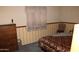 Charming bedroom featuring patterned wallpaper, cozy bedding, and traditional furnishings at 8802 W Cinnabar Ave, Peoria, AZ 85345