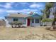 Single-story home with a red door and basic landscaping, set against a clear sky at 8802 W Cinnabar Ave, Peoria, AZ 85345