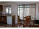 Kitchen with an adjacent dining area, natural light through a large window, tile floor, and white dishwasher at 8802 W Cinnabar Ave, Peoria, AZ 85345