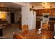 Open-concept kitchen and dining area; wood cabinets and white appliances for a functional cooking space at 8802 W Cinnabar Ave, Peoria, AZ 85345