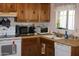 Functional kitchen with ample cabinet space, essential appliances, and a window over the sink at 8802 W Cinnabar Ave, Peoria, AZ 85345