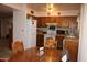 Full kitchen view with dining area featuring wood cabinets, and white appliances at 8802 W Cinnabar Ave, Peoria, AZ 85345