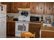 Cozy kitchen with wooden cabinets, white appliances, and a practical layout at 8802 W Cinnabar Ave, Peoria, AZ 85345