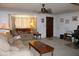 Comfortable living room featuring cozy seating, a bay window and carpeted floors at 8802 W Cinnabar Ave, Peoria, AZ 85345