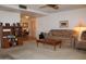 Inviting living area showcasing carpeted flooring, ample seating, and an open layout at 8802 W Cinnabar Ave, Peoria, AZ 85345