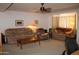 Spacious living room with a ceiling fan, comfortable furniture, and natural light at 8802 W Cinnabar Ave, Peoria, AZ 85345
