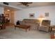 Comfortable living room with neutral carpet, ceiling fan, and a large seating area for relaxation at 8802 W Cinnabar Ave, Peoria, AZ 85345