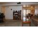 Open-concept living room with a view into the dining area, featuring neutral decor and wooden furniture at 8802 W Cinnabar Ave, Peoria, AZ 85345