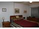 Cozy bedroom with a decorative bedspread, wooden furniture, and classic decor at 8802 W Cinnabar Ave, Peoria, AZ 85345