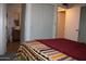 A main bedroom showcasing a serene sleeping space with a private ensuite bathroom at 8802 W Cinnabar Ave, Peoria, AZ 85345