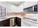Well-lit kitchen features updated appliances, including a stainless steel dishwasher and stove at 930 N Mesa Dr # 1079, Mesa, AZ 85201
